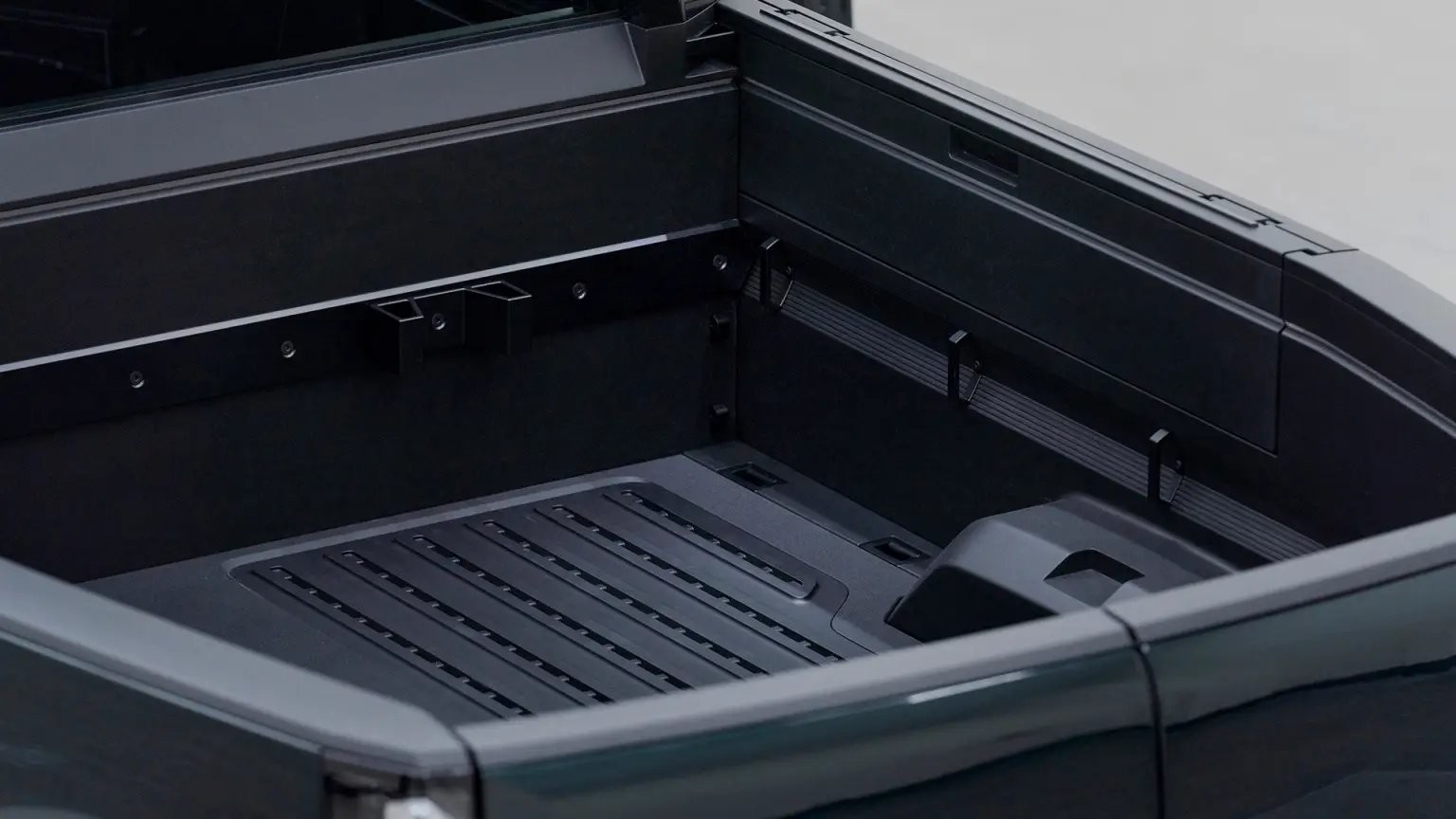 A purpose-built trcuk Canoo pickup w 8 ft bed with ample storage interior