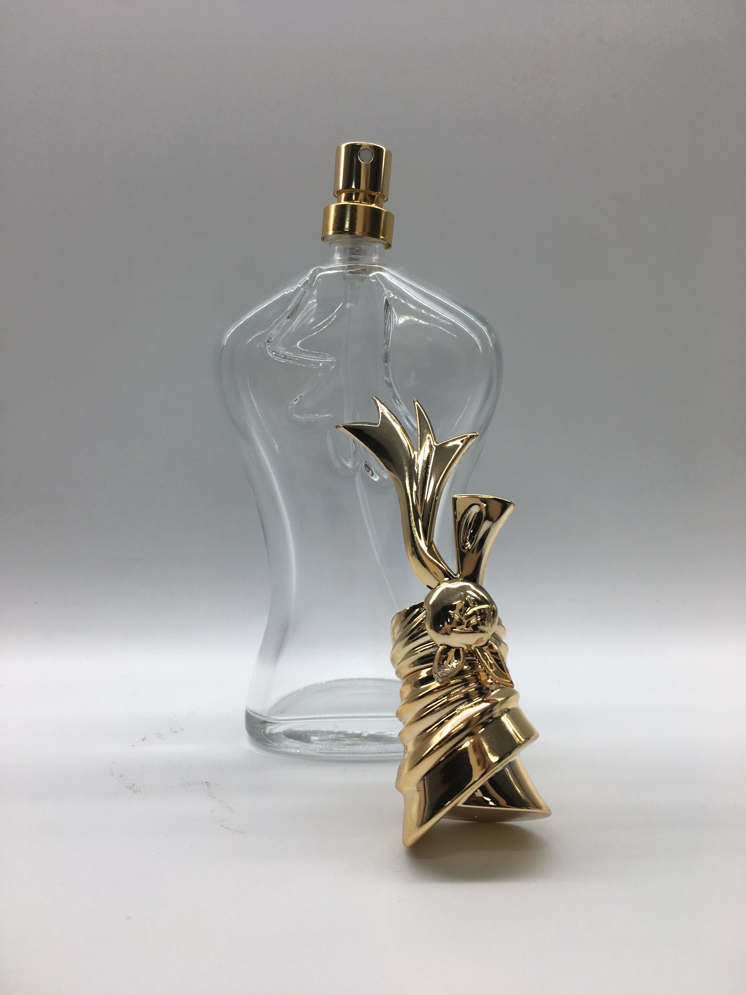 Embossed Logo Empty Perfume Glass Bottles Body Shape Unique Cap 100ml