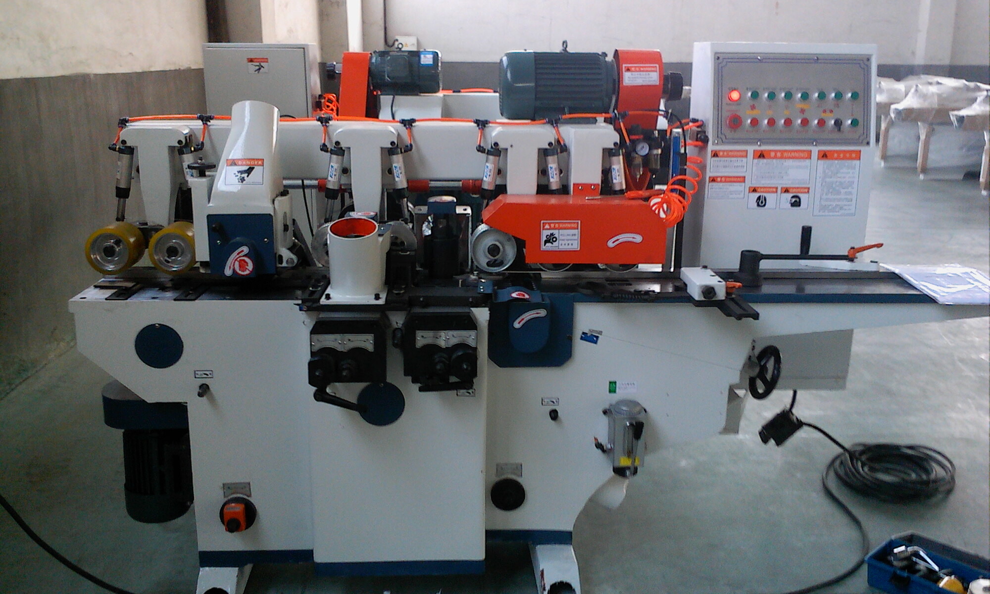 Four sided picture frame moulding machine