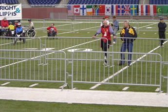 The crowd control barriers are installed on the stadium and several players on the grassland.